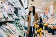 image of a woman shopping in the grocery store with her daughter in a stroller