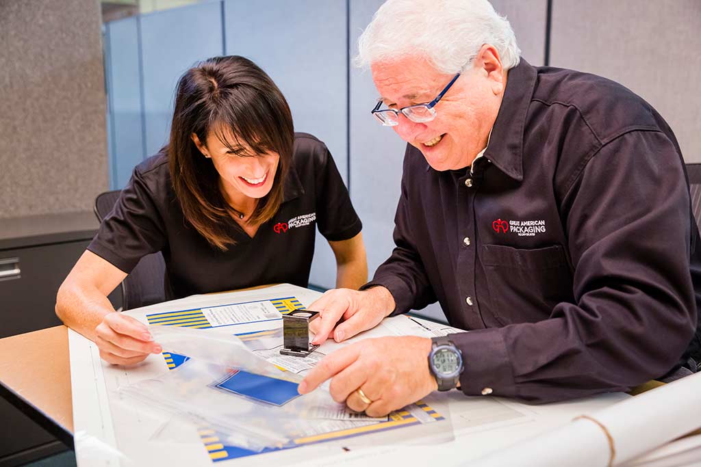 Great American Packaging father and daughter inspecting packaging products