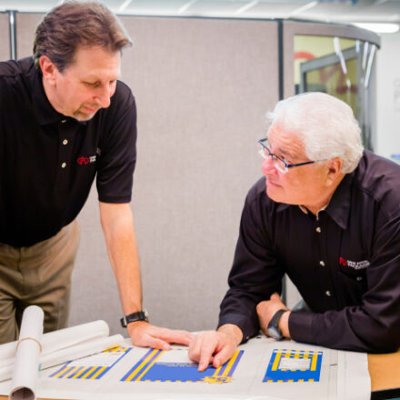 two great american packaging employees looking over product specifications