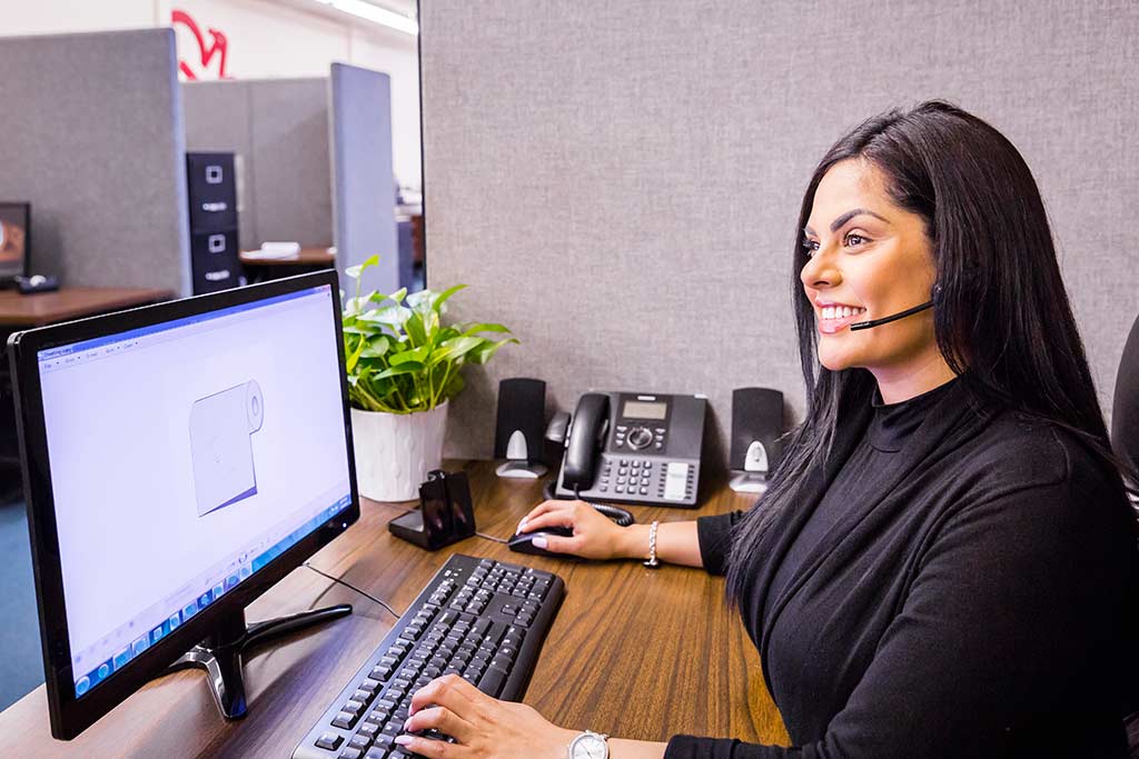 smiling customer service representative at her computer