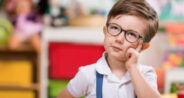 image of a young child in glasses thinking