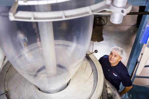 image of GAP employee looking at bags being in production