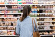 image of woman looking at food shelves at the grocery store